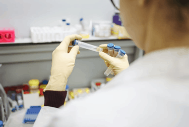 doctor in a lab with blood test tubes